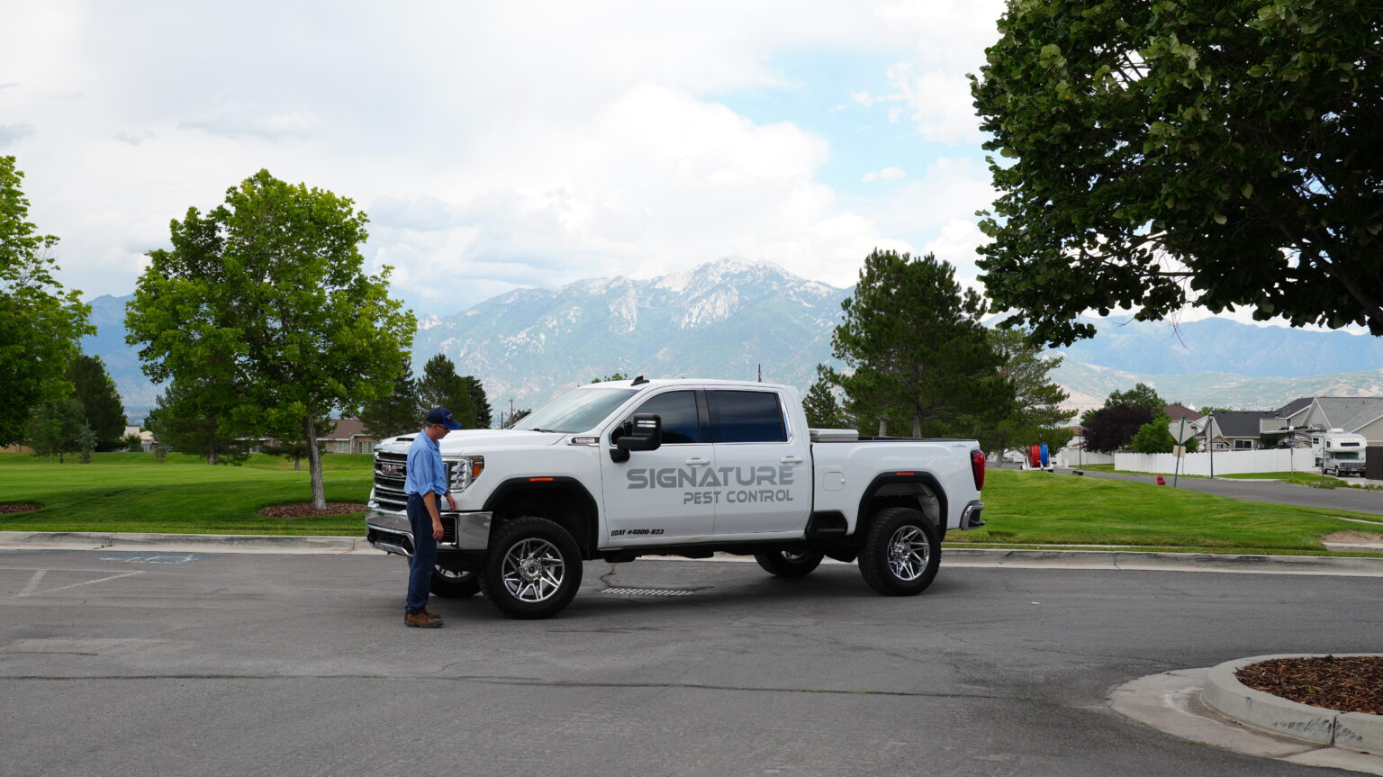 Signature Pest Control truck with the Wasatch Mountains behind it